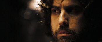 Movie still from “Deja Vu” (2006), directed by Tony Scott – A person with a beard looking at the camera; Close Up shot, Over the shoulder angle