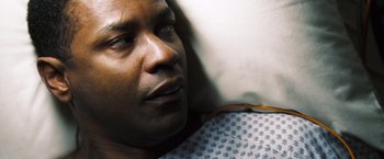 Movie still from “Deja Vu” (2006), directed by Tony Scott – A man in a hospital bed; Close Up shot, Overhead angle