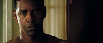 Movie still from “Deja Vu” (2006), directed by Tony Scott – A man's face in front of a window; Close Up shot, Over the shoulder angle