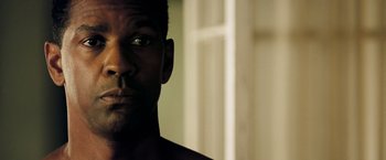 Movie still from “Deja Vu” (2006), directed by Tony Scott – A man's face in front of a white door; Close Up shot, Over the shoulder angle