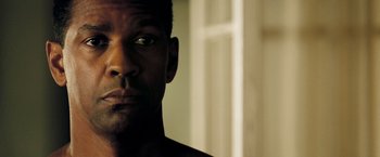Movie still from “Deja Vu” (2006), directed by Tony Scott – A man's face in front of a white door; Close Up shot, Low angle