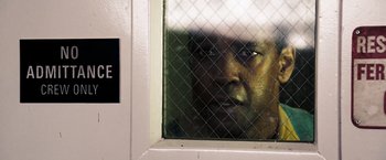 Movie still from “Deja Vu” (2006), directed by Tony Scott – A person looking out of a window; Close Up shot, Over the shoulder angle