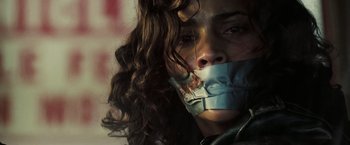 Movie still from “Deja Vu” (2006), directed by Tony Scott – A woman with a mouth taped shut; Close Up shot, Low angle