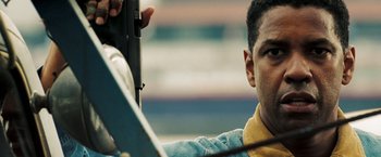 Movie still from “Deja Vu” (2006), directed by Tony Scott – A man sitting in a car holding a cell phone; Close Up shot, Low angle