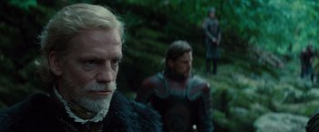 Movie still from “Dracula Untold” (2014), directed by Gary Shore – A man with long hair and a beard standing in front of another man with long hair; Close Up shot, Low angle