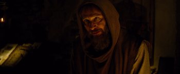 Movie still from “Dracula Untold” (2014), directed by Gary Shore – A man with a beard wearing a robe and a hood; Close Up shot, Low angle