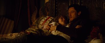Movie still from “Dracula Untold” (2014), directed by Gary Shore – A man and a woman sitting next to each other on a couch; Medium shot, High angle