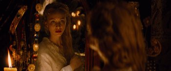 Movie still from “Dracula Untold” (2014), directed by Gary Shore – A woman looking into a mirror in front of a tree; Close Up shot, Over the shoulder angle