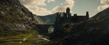 Movie still from “Dracula Untold” (2014), directed by Gary Shore – A castle on top of a hill near a body of water; Extreme Wide shot, High angle