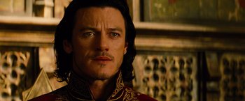 Movie still from “Dracula Untold” (2014), directed by Gary Shore – A person with long black hair; Close Up shot, Over the shoulder angle