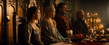 Movie still from “Dracula Untold” (2014), directed by Gary Shore – A group of people sitting around a table; Medium shot, Over the shoulder angle