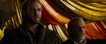 Movie still from “Dracula Untold” (2014), directed by Gary Shore – A man and a woman standing next to each other in a room; Close Up shot, Low angle