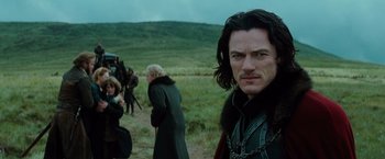 Movie still from “Dracula Untold” (2014), directed by Gary Shore – A person wearing a chain around their neck; Close Up shot, Over the shoulder angle