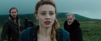 Movie still from “Dracula Untold” (2014), directed by Gary Shore – A young woman with long blonde hair standing next to a man; Close Up shot, Over the shoulder angle