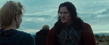 Movie still from “Dracula Untold” (2014), directed by Gary Shore – A person wearing a chain around their neck; Close Up shot, Over the shoulder angle