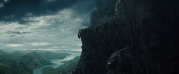 Movie still from “Dracula Untold” (2014), directed by Gary Shore – A man is climbing up the side of a mountain; Extreme Wide shot, Low angle