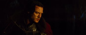 Movie still from “Dracula Untold” (2014), directed by Gary Shore – A person wearing a chain; Close Up shot, Over the shoulder angle