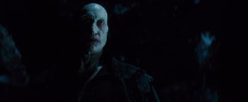 Movie still from “Dracula Untold” (2014), directed by Gary Shore – A man with a bald head is looking at the camera; Close Up shot, Over the shoulder angle