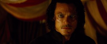 Movie still from “Dracula Untold” (2014), directed by Gary Shore – A person wearing a black shirt; Close Up shot, Over the shoulder angle