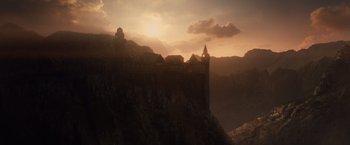Movie still from “Dracula Untold” (2014), directed by Gary Shore – The sun is setting behind a castle on a hill; Extreme Wide shot, Low angle
