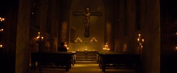 Movie still from “Dracula Untold” (2014), directed by Gary Shore – A large crucifixion statue in the middle of a church; Extreme Wide shot, Low angle