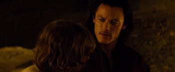 Movie still from “Dracula Untold” (2014), directed by Gary Shore – A man with long black hair looking at another man with long brown hair; Close Up shot, Over the shoulder angle