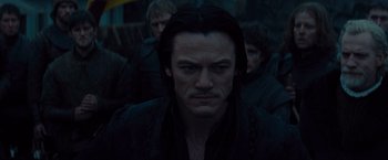 Movie still from “Dracula Untold” (2014), directed by Gary Shore – A person with long black hair; Close Up shot, Over the shoulder angle