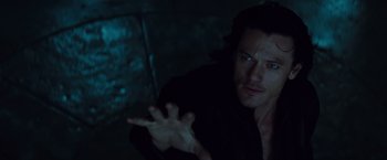 Movie still from “Dracula Untold” (2014), directed by Gary Shore – A man in a black shirt is holding his hand out; Close Up shot, Overhead angle