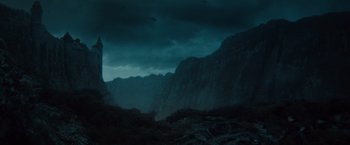 Movie still from “Dracula Untold” (2014), directed by Gary Shore – A dark sky over a mountain range with a dark sky above it; Extreme Wide shot, Low angle