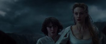 Movie still from “Dracula Untold” (2014), directed by Gary Shore – Two people standing next to each other in a dark room; Medium shot, Low angle