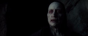 Movie still from “Dracula Untold” (2014), directed by Gary Shore – An old man with white skin and a black face; Close Up shot, Over the shoulder angle