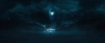 Movie still from “Dracula Untold” (2014), directed by Gary Shore – A man standing in the middle of a field under a cloudy sky; Extreme Wide shot, Low angle