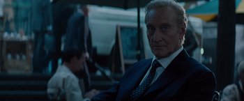 Movie still from “Dracula Untold” (2014), directed by Gary Shore – An older man wearing a suit and tie; Close Up shot, Over the shoulder angle