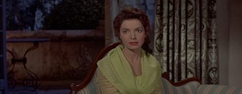 Movie still from “Désirée” (1954), directed by Henry Koster – A woman sitting in a chair wearing a yellow scarf; Close Up shot, High angle