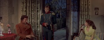 Movie still from “Désirée” (1954), directed by Henry Koster – A man in a military uniform standing in front of a door; Medium shot, Over the shoulder angle