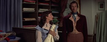 Movie still from “Désirée” (1954), directed by Henry Koster – A man and a woman standing next to each other in a room; Medium shot, Over the shoulder angle