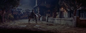 Movie still from “Désirée” (1954), directed by Henry Koster – A man riding a horse in a dark place; Wide shot, High angle