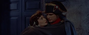 Movie still from “Désirée” (1954), directed by Henry Koster – A man and a woman in military garb are kissing; Close Up shot, Low angle