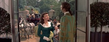 Movie still from “Désirée” (1954), directed by Henry Koster – A man and a woman talking to each other in front of a crowd of onlookers; Medium shot, Over the shoulder angle