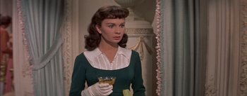 Movie still from “Désirée” (1954), directed by Henry Koster – A woman holding a glass of wine while wearing gloves; Close Up shot, Low angle