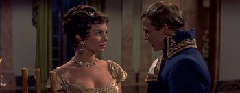 Movie still from “Désirée” (1954), directed by Henry Koster – A man and a woman in formal wear looking at one another; Close Up shot, Over the shoulder angle