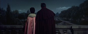 Movie still from “Désirée” (1954), directed by Henry Koster – A man and a woman dressed in medieval garb looking out over a city at night; Medium shot, Low angle
