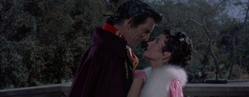 Movie still from “Désirée” (1954), directed by Henry Koster – A man and a woman standing next to each other in front of a tree; Medium shot, Over the shoulder angle