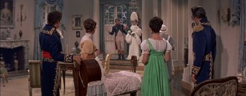 Movie still from “Désirée” (1954), directed by Henry Koster – A group of people standing in front of a room; Wide shot, Over the shoulder angle