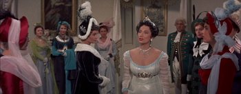 Movie still from “Désirée” (1954), directed by Henry Koster – Two women dressed up in fancy costumes and hats; Medium shot, Over the shoulder angle