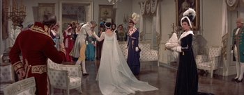 Movie still from “Désirée” (1954), directed by Henry Koster – A group of people standing in a living room; Wide shot, High angle