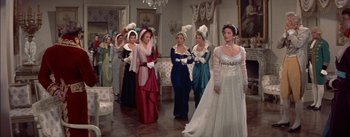 Movie still from “Désirée” (1954), directed by Henry Koster – A group of women in formal dresses in a room; Wide shot, Over the shoulder angle