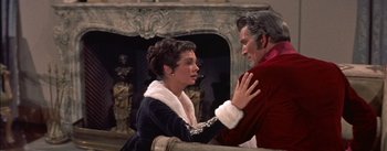 Movie still from “Désirée” (1954), directed by Henry Koster – A woman and a man in front of a fire place; Medium shot, Over the shoulder angle