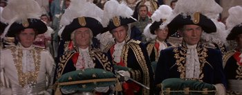 Movie still from “Désirée” (1954), directed by Henry Koster – A group of men in costumes are standing together; Medium shot, High angle