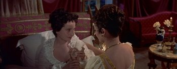 Movie still from “Désirée” (1954), directed by Henry Koster – Two women in ancient roman garb holding a glass; Close Up shot, High angle